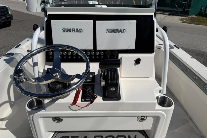 Slide: The Image of 2021 Sea Born FX24 Bay boat dashboard with Simrad displays and steering wheel. - 8