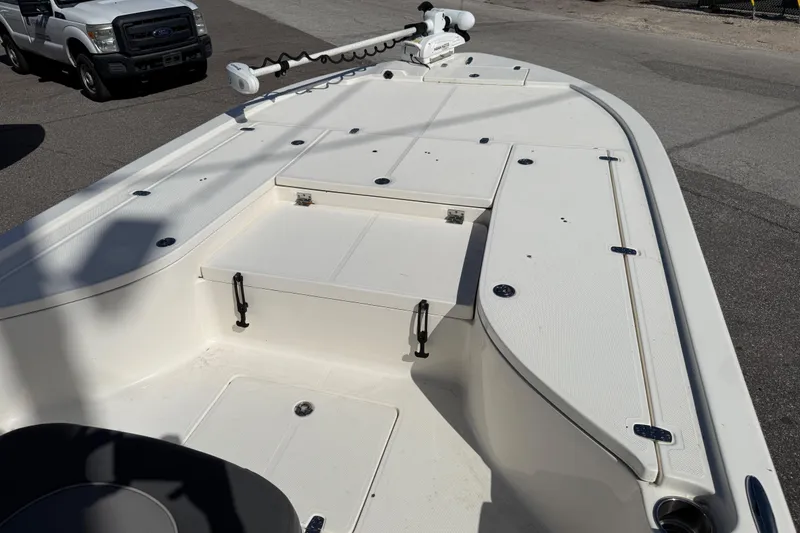 Slide: The Image of 2021 Sea Born FX24 Bay boat deck with storage compartments and trolling motor. - 9