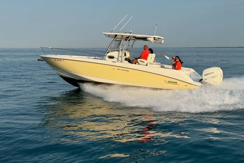 The Image of 2006 Boston Whaler 320 Outrage cruising on open water with passengers. - 0