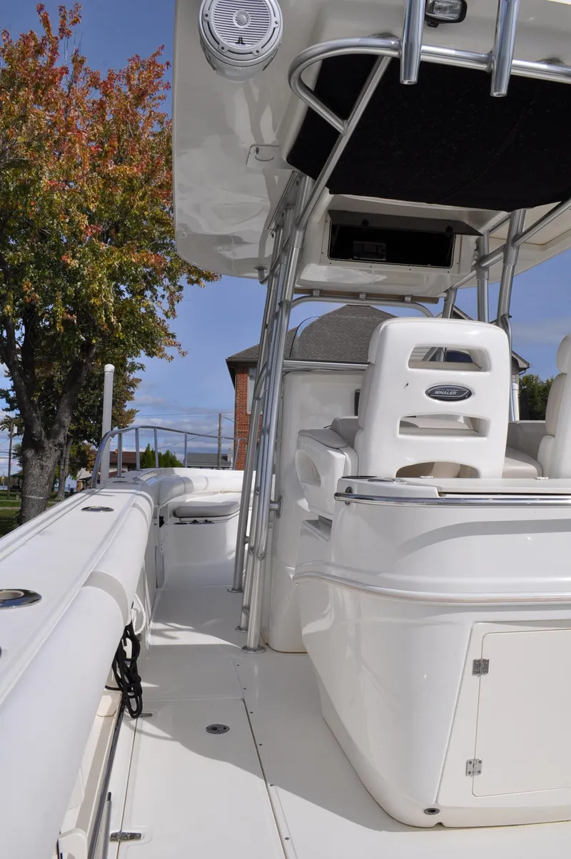 Slide: The Image of 2006 Boston Whaler 320 Outrage, interior view, white seating, sunny day. - 12
