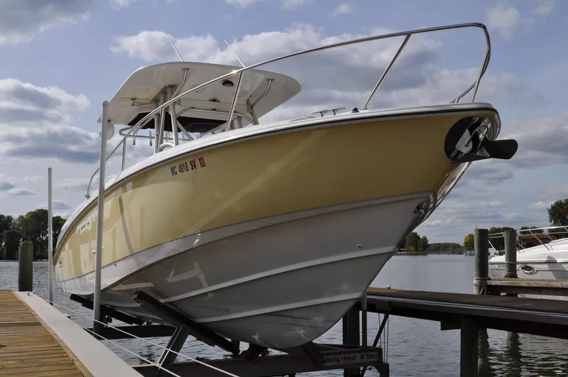 Slide: The Image of 2006 Boston Whaler 320 Outrage on a boat lift at the dock. - 3
