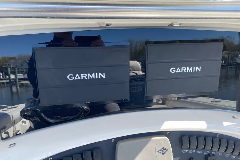 Slide: The Image of Dual Garmin displays on 2006 Boston Whaler 320 Outrage boat dashboard. - 7