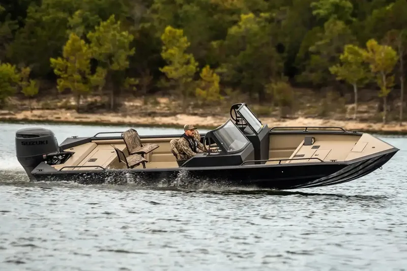 Slide: The Image of 2026 SeaArk Protege 240 boat, red, parked on a trailer in a lot. - 10