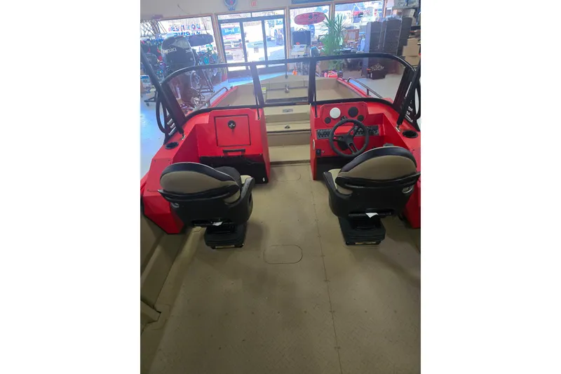 Slide: The Image of 2026 SeaArk Protege 240 boat in showroom, featuring red and tan design. - 3