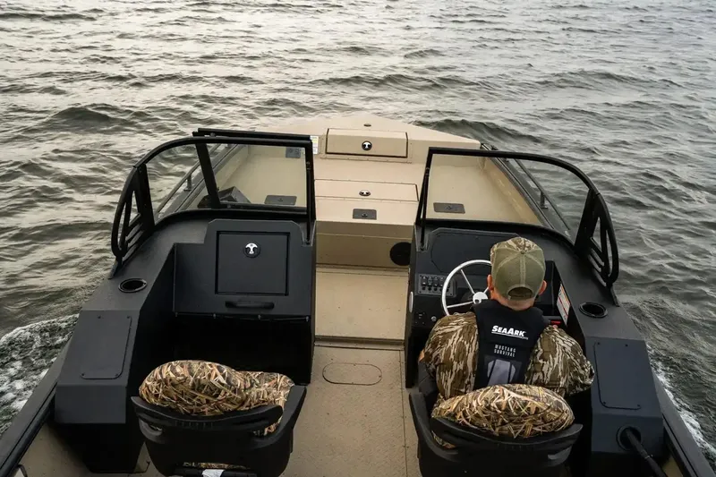 Slide: The Image of Interior view of 2026 SeaArk Protege 240 boat with dual seats and red dashboard. - 8