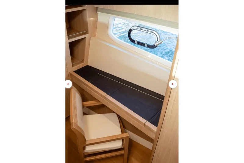 Slide: The Image of Interior of 2018 Aquila 44 Yacht with desk, chair, and window view. - 11
