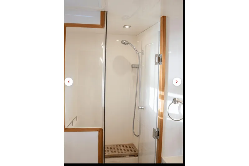 Slide: The Image of Shower area in 2018 Aquila 44 Yacht with glass door and wooden accents. - 13