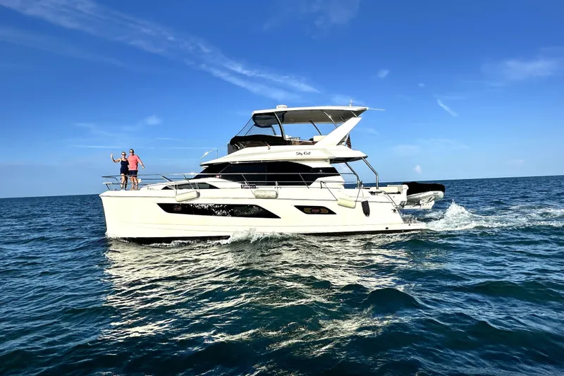 Slide: The Image of 2018 Aquila 44 Yacht cruising on open sea under clear blue sky. - 2