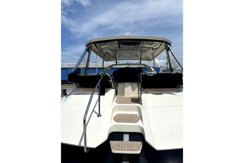 Slide: The Image of 2018 Aquila 44 Yacht, rear view with steps, under a clear blue sky. - 21