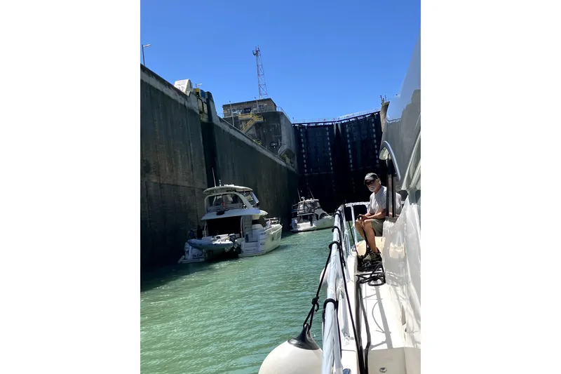 Slide: The Image of Aquila 44 Yacht navigating a canal lock with other boats, 2018 model. - 26