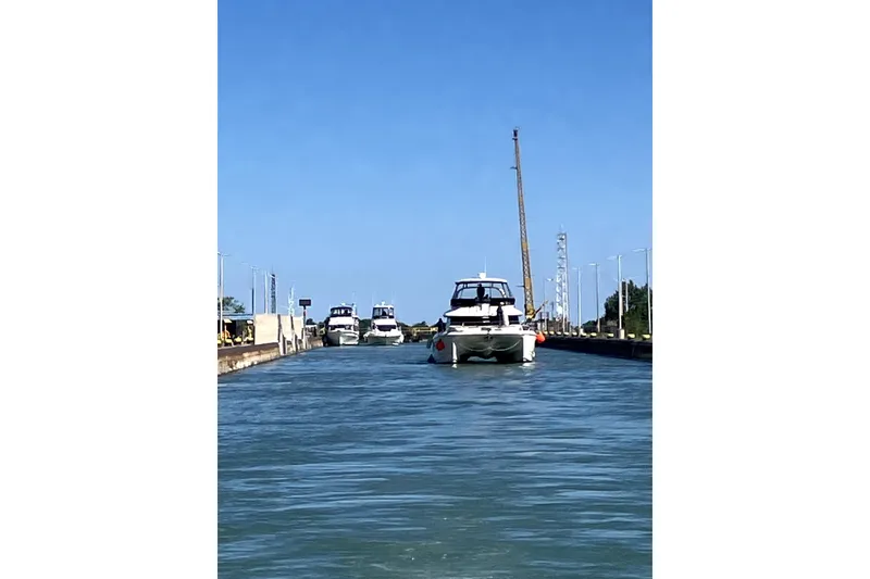 Slide: The Image of Aquila 44 Yacht 2018 navigating a canal with clear blue skies. - 27