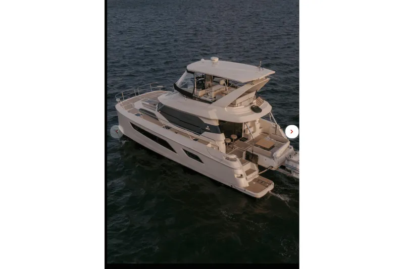 Slide: The Image of 2018 Aquila 44 Yacht cruising on open water at sunset. - 31