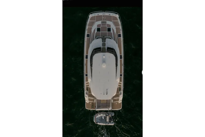 Slide: The Image of Aerial view of 2018 Aquila 44 Yacht cruising on dark water. - 32