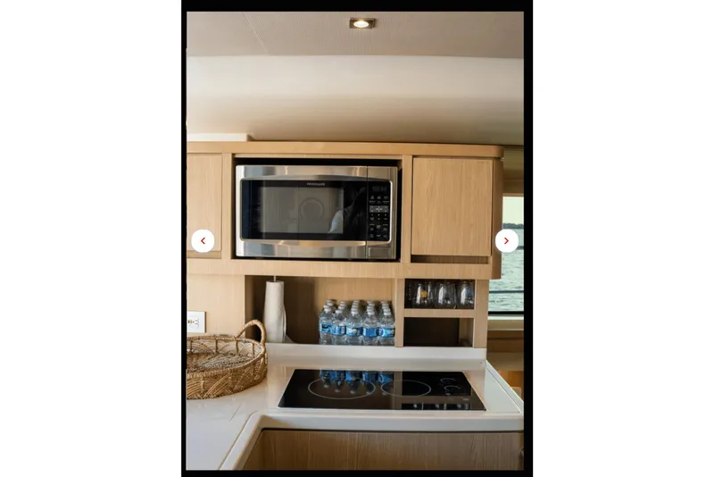 Slide: The Image of Modern kitchen area in 2018 Aquila 44 Yacht with microwave and stovetop. - 4