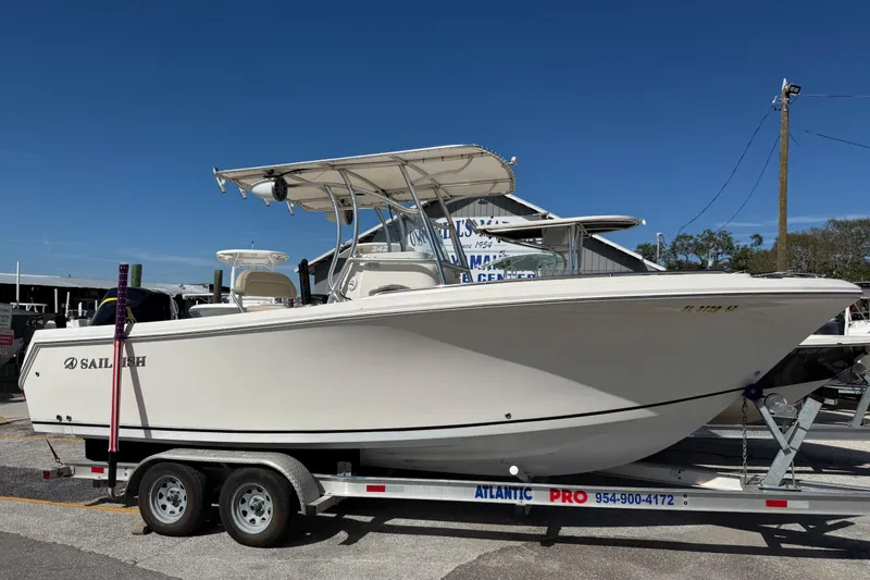 The Image of 2021 Sailfish 242 CC boat on trailer under clear blue sky. - 1