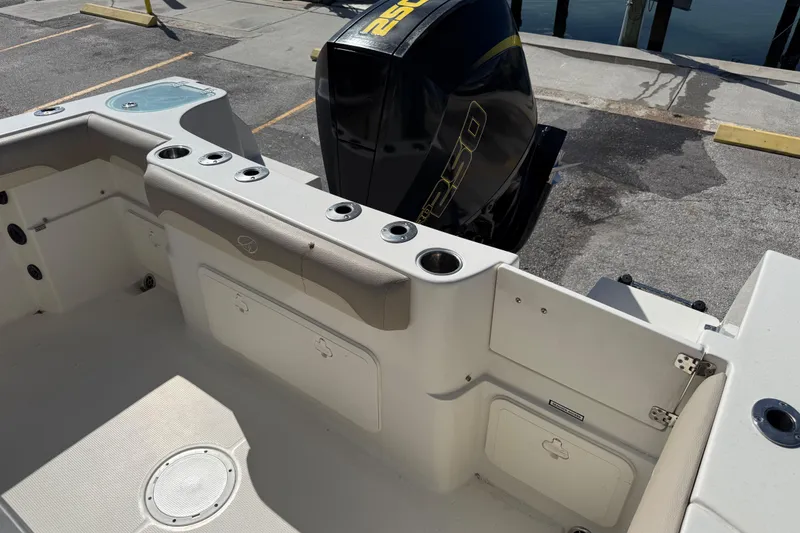 Slide: The Image of 2021 Sailfish 242 CC boat interior with Yamaha 250 engine at dock. - 17