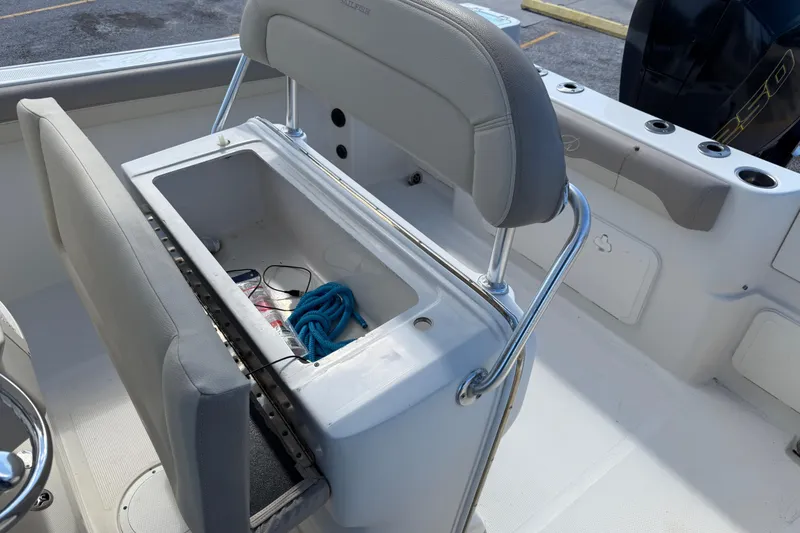 Slide: The Image of 2021 Sailfish 242 CC boat interior with open storage compartment and blue rope. - 18