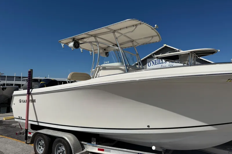 Slide: The Image of 2021 Sailfish 242 CC boat on trailer under clear blue sky. - 3