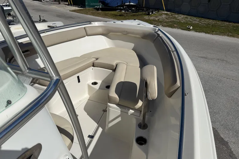 Slide: The Image of 2021 Sailfish 242 CC boat with cushioned seating and stainless steel railings. - 9