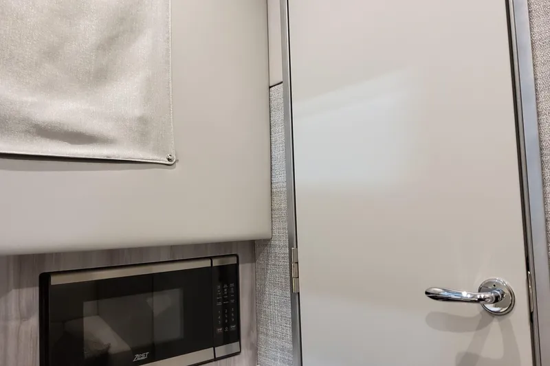 Slide: The Image of Interior of 2026 Formula 360 Crossover Bowrider OB with microwave and sleek door handle. - 100