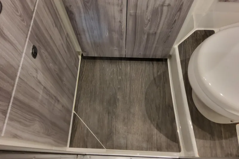 Slide: The Image of Bathroom interior of 2026 Formula 360 Crossover Bowrider OB with wood finish. - 105