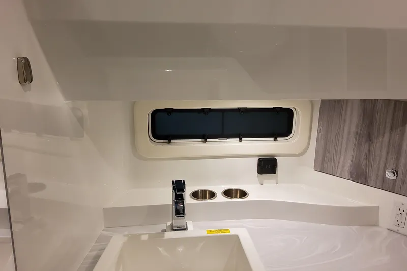 Slide: The Image of Interior of 2026 Formula 360 Crossover Bowrider OB, featuring modern sink and window. - 108