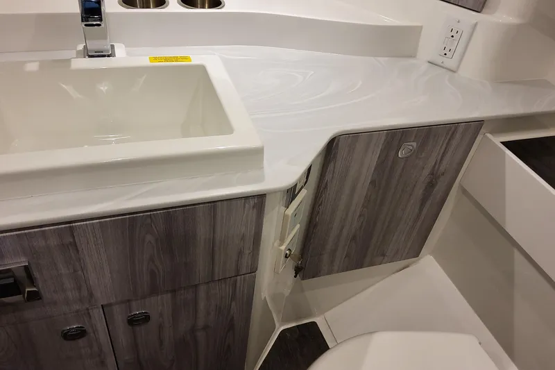 Slide: The Image of 2026 Formula 360 Crossover Bowrider OB bathroom with modern sink and wood cabinetry. - 112