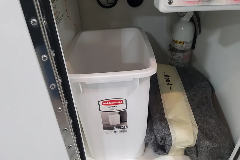 Slide: The Image of Storage compartment in a 2026 Formula 360 Crossover Bowrider OB with wastebasket and fire extinguisher. - 122