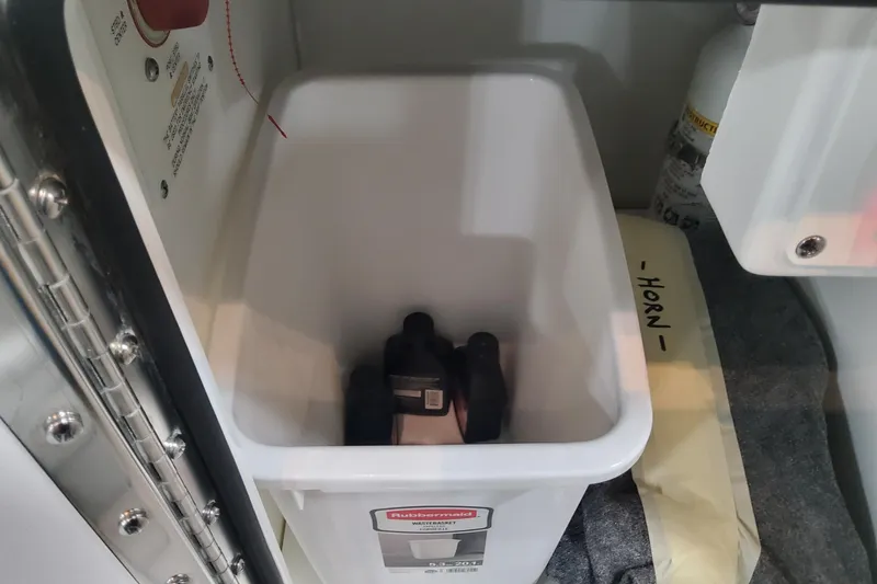 Slide: The Image of Storage compartment in 2026 Formula 360 Crossover Bowrider OB with Rubbermaid container. - 123