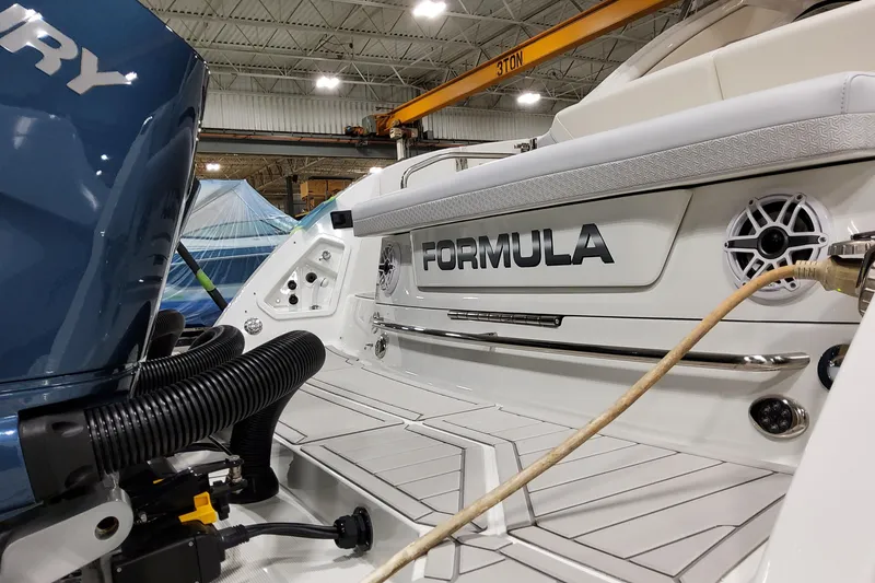 Slide: The Image of 2026 Formula 360 Crossover Bowrider OB in a warehouse, showcasing its sleek design and branding. - 13