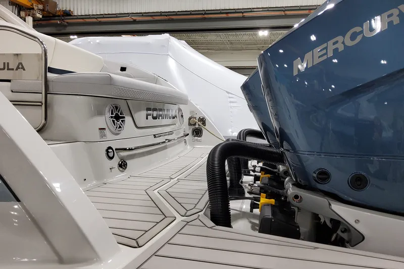 Slide: The Image of 2026 Formula 360 Crossover Bowrider OB with Mercury outboard engines in a showroom. - 14