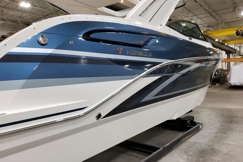 Slide: The Image of 2026 Formula 360 Crossover Bowrider OB in a showroom, showcasing sleek blue and white design. - 4