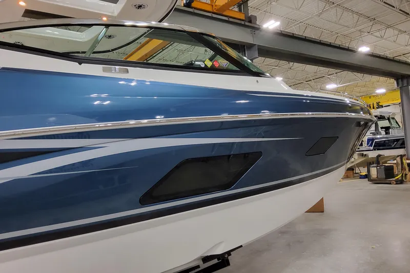 Slide: The Image of 2026 Formula 360 Crossover Bowrider OB in a showroom, showcasing sleek blue design. - 6