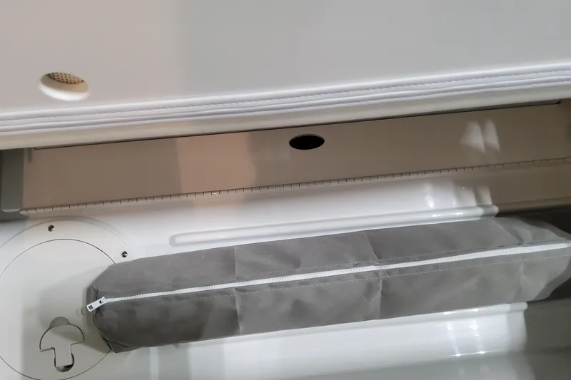 Slide: The Image of Storage compartment in 2026 Formula 360 Crossover Bowrider OB boat, featuring a zippered cushion. - 65