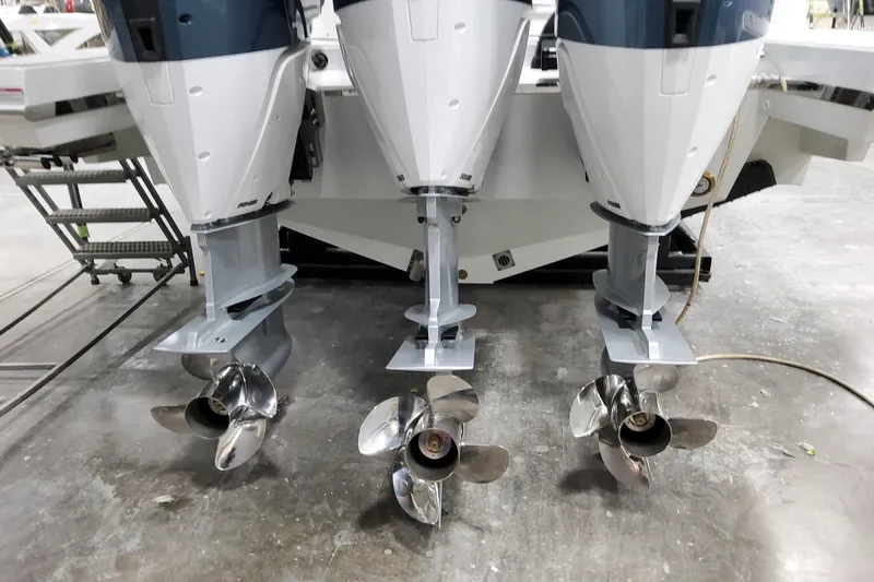 Slide: The Image of 2026 Formula 360 Crossover Bowrider OB with triple outboard engines in a workshop setting. - 9