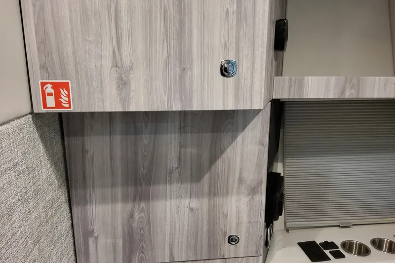 Slide: The Image of Wooden interior of 2026 Formula 360 Crossover Bowrider OB with fire extinguisher sign. - 92