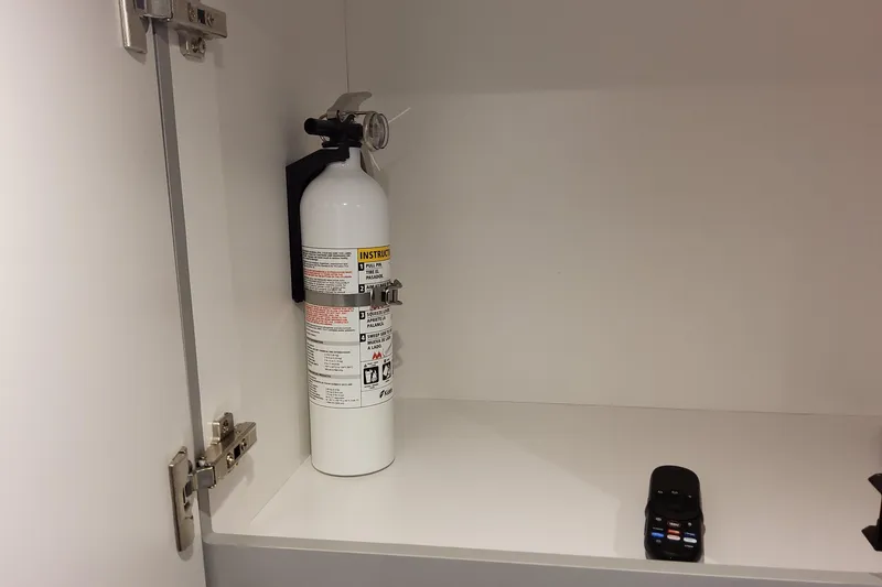 Slide: The Image of Fire extinguisher and remote in cabinet of 2026 Formula 360 Crossover Bowrider OB. - 93
