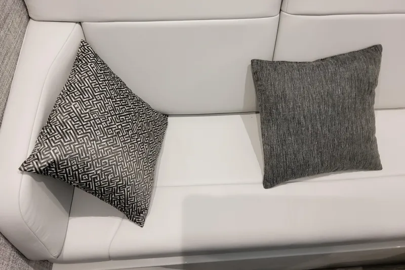 Slide: The Image of White leather seating with patterned and plain gray cushions on a 2026 Formula 360 Crossover Bowrider OB. - 95