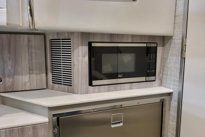 Slide: The Image of 2026 Formula 360 Crossover Bowrider OB interior with modern microwave and cabinetry. - 99