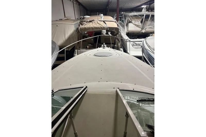 Slide: The Image of 2000 Cruisers Yachts 2870 Express in storage, surrounded by other boats. - 16