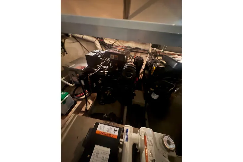 Slide: The Image of Engine compartment of 2000 Cruisers Yachts 2870 Express, showcasing mechanical components and wiring. - 18