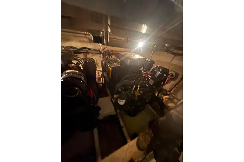 Slide: The Image of Engine room of 2000 Cruisers Yachts 2870 Express, showcasing dual engines and mechanical components. - 19