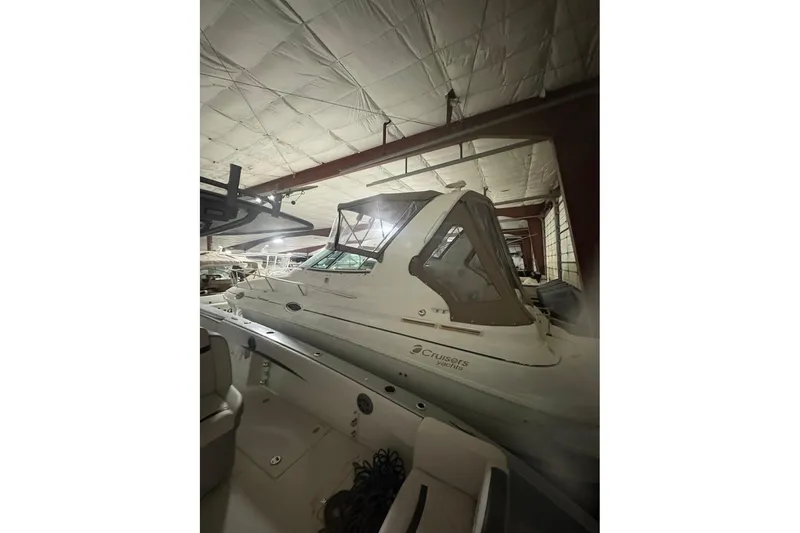 Slide: The Image of Interior of 2000 Cruisers Yachts 2870 Express, featuring seating and a small table. - 2