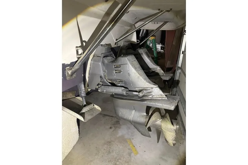 Slide: The Image of 2000 Cruisers Yachts 2870 Express boat propellers and stern drive in a garage. - 22