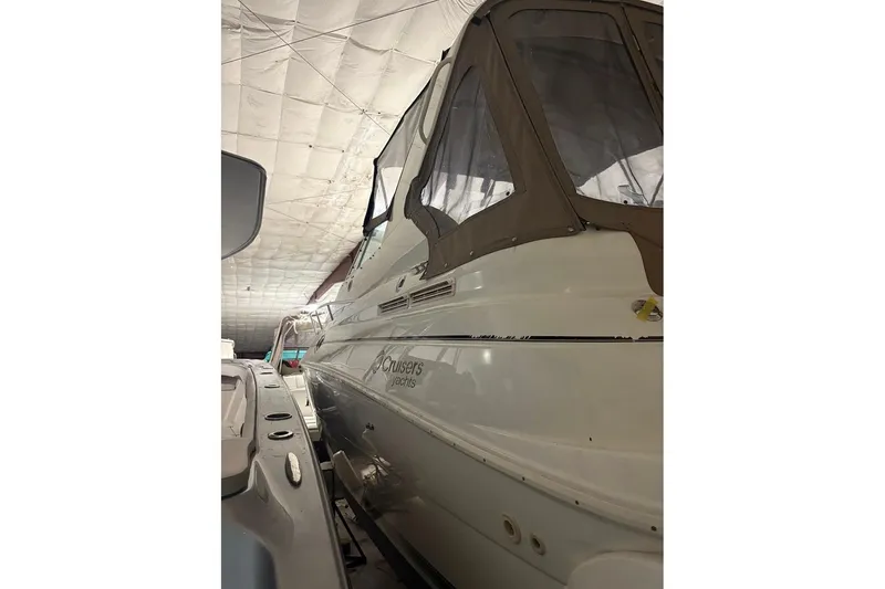 Slide: The Image of 2000 Cruisers Yachts 2870 Express helm with steering wheel and control panel. - 3