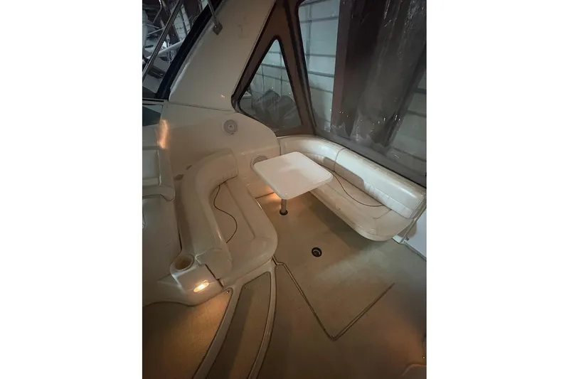 Slide: The Image of Interior of 2000 Cruisers Yachts 2870 Express with beige seating and carpet. - 6