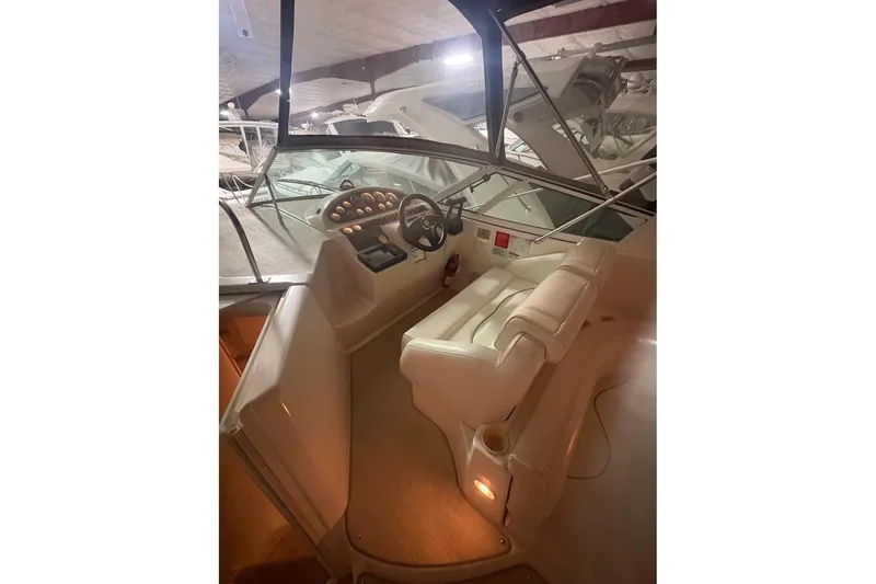 Slide: The Image of Interior of 2000 Cruisers Yachts 2870 Express with beige seating and table. - 8