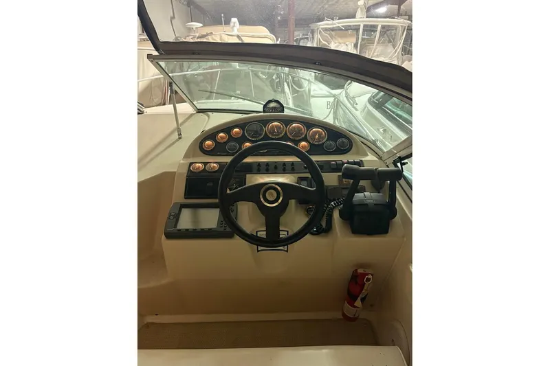 Slide: The Image of 2000 Cruisers Yachts 2870 Express interior with helm and seating area. - 9