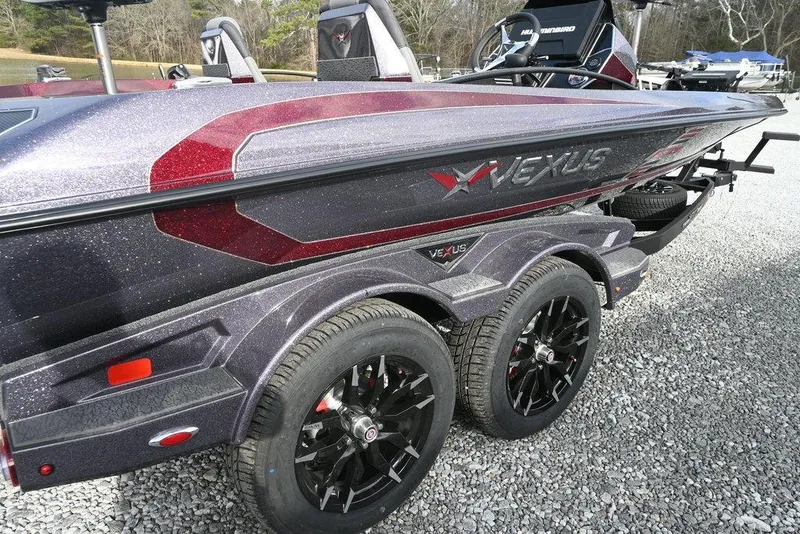 Slide: The Image of 2026 Vexus VXs20 boat with sleek design and dual-axle trailer on gravel surface. - 2