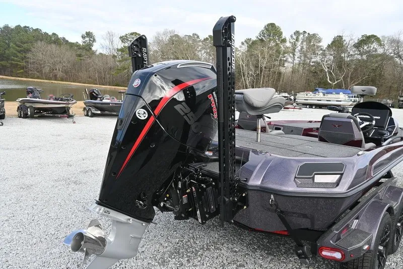 Slide: The Image of 2026 Vexus VXs20 boat with powerful outboard motor, parked on gravel near a lake. - 9